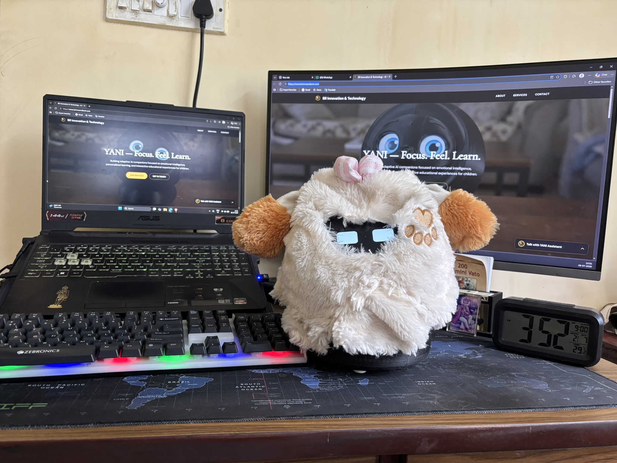 YANI showing a bright blue expression beside the development screens